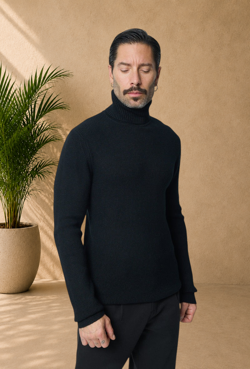 Stayin black ribbed knit turtleneck sweater worn by a male model with a mustache