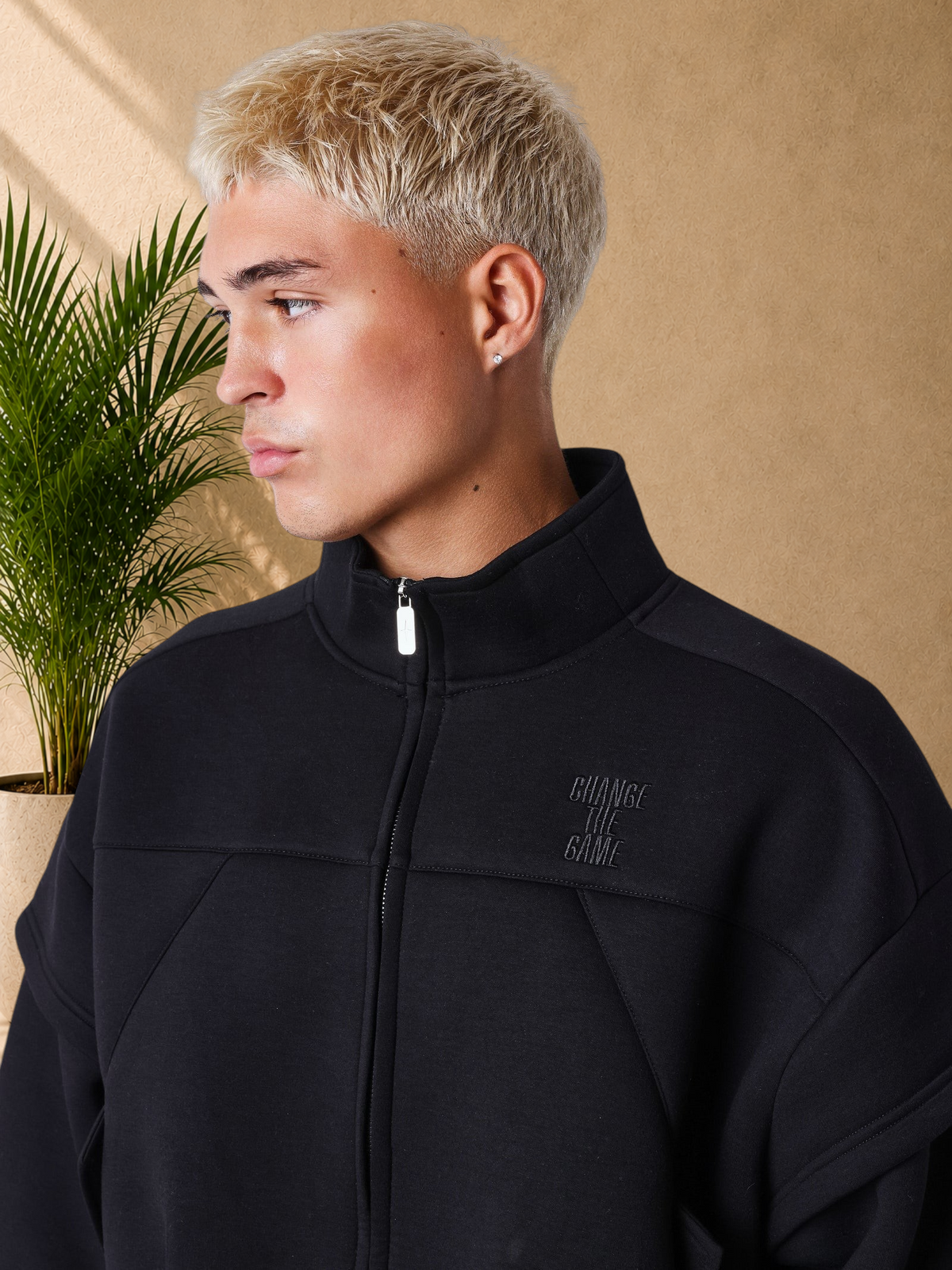 Stayin black neoprene boxy fit zip-up vest with high collar and structured panels worn by a blonde model