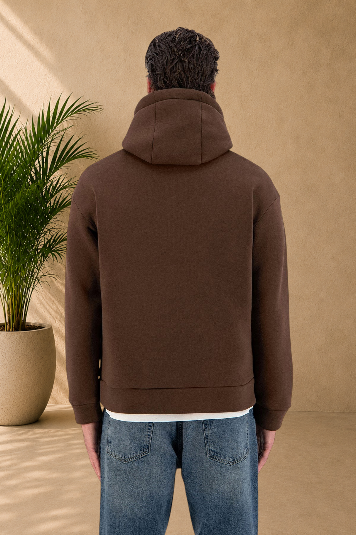 Stayin brown quilted hoodie worn by a model, back view showing thick fabric and comfortable fit
