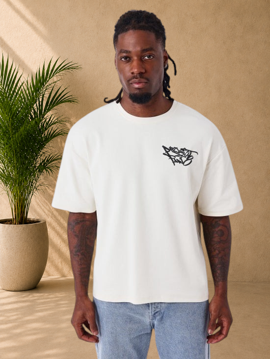 Stayin beige oversized cotton t-shirt with black graffiti logo on chest and graphic print on back