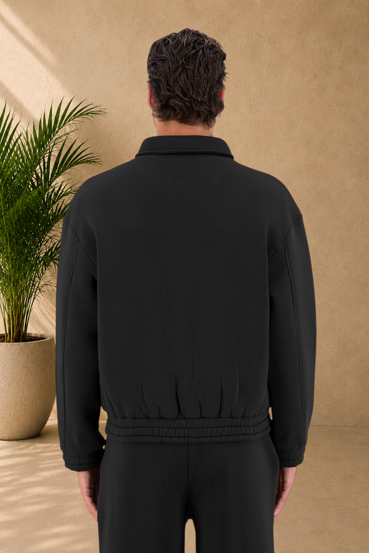 Stayin black padded oversized jacket with a collared neckline, back view on a model