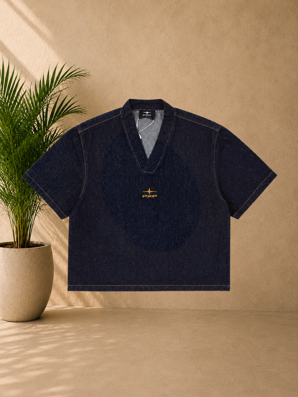 Stayin PXP boxy fit raw denim V-neck t-shirt in dark blue with orange contrast stitching and chest logo embroidery.