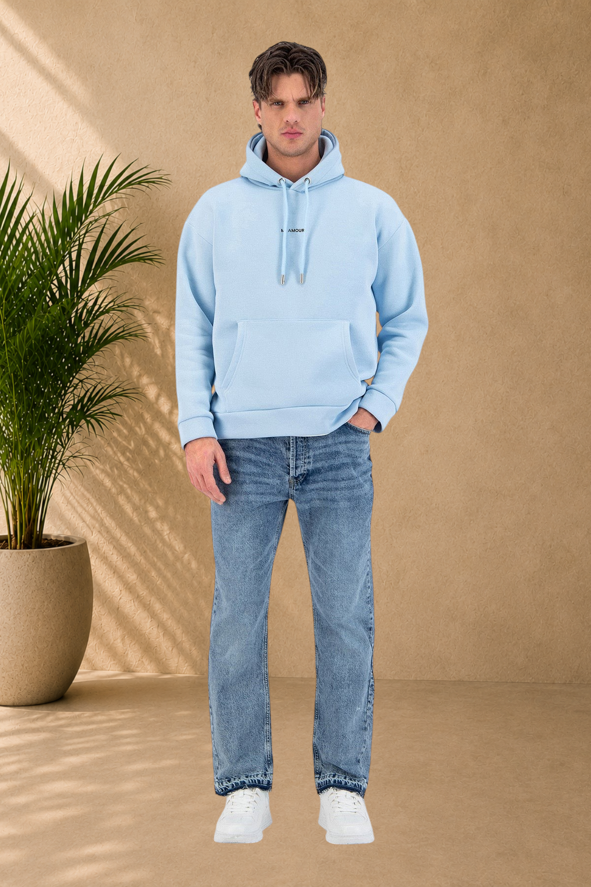 Stayin light blue quilted hoodie with drawstring worn by a male model with blue jeans and white sneakers
