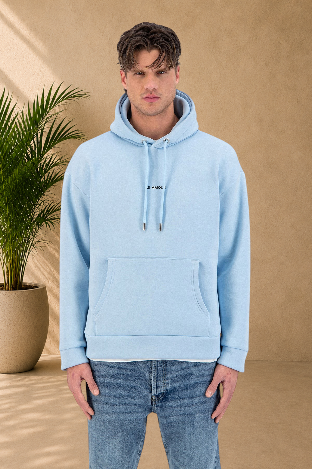 Stayin light blue quilted hoodie with Amore print worn by a male model against a white background