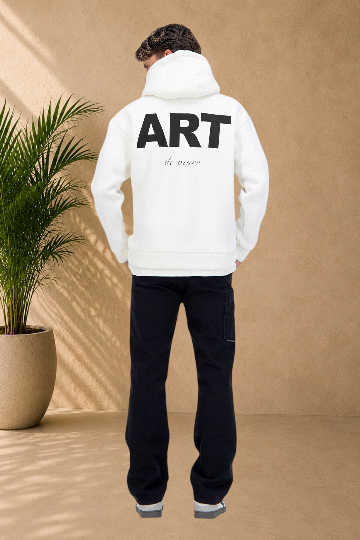 Stayin white quilted hoodie with ART graphic on the back worn by a model from behind