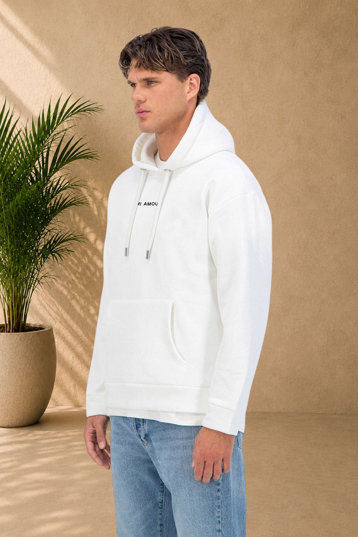 Stayin white Amore hoodie with thick quilted fabric and drawstring hood worn by a male model in profile view