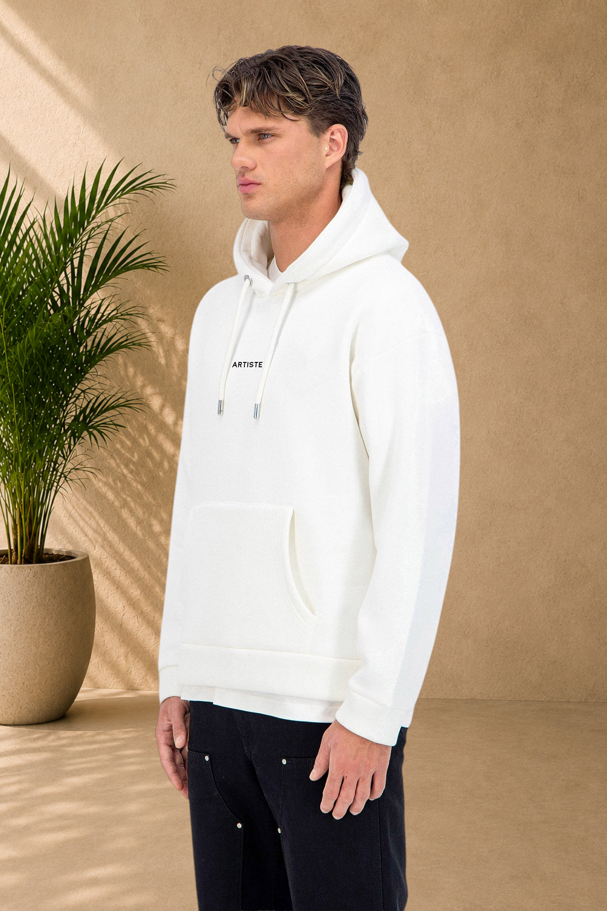 Stayin white quilted hoodie with ARTISTE print worn by a male model on a white background