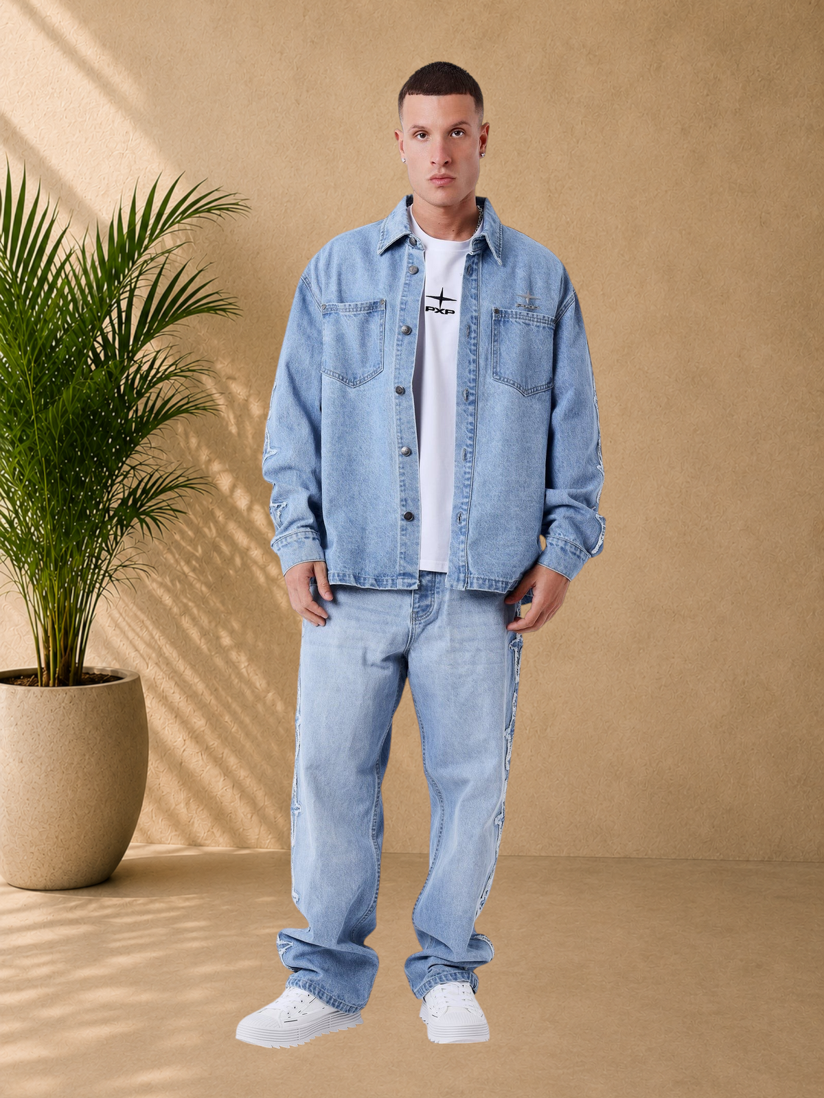 Stayin PXP Polaris blue loose-fit denim jacket with button closure, chest pockets, and sleeve detailing on a model.