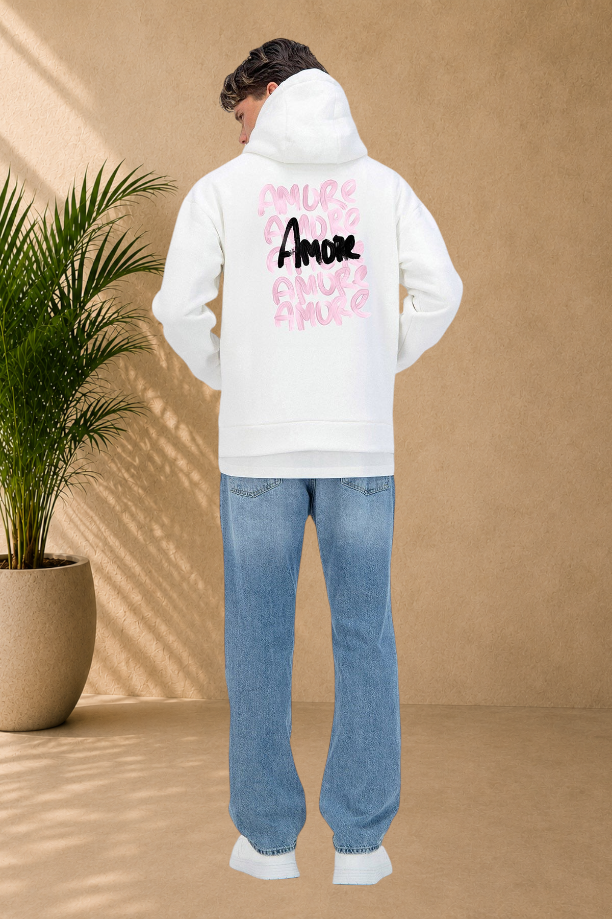 Stayin white quilted hoodie with pink and black Amore graphic print on the back, worn by a man in blue jeans