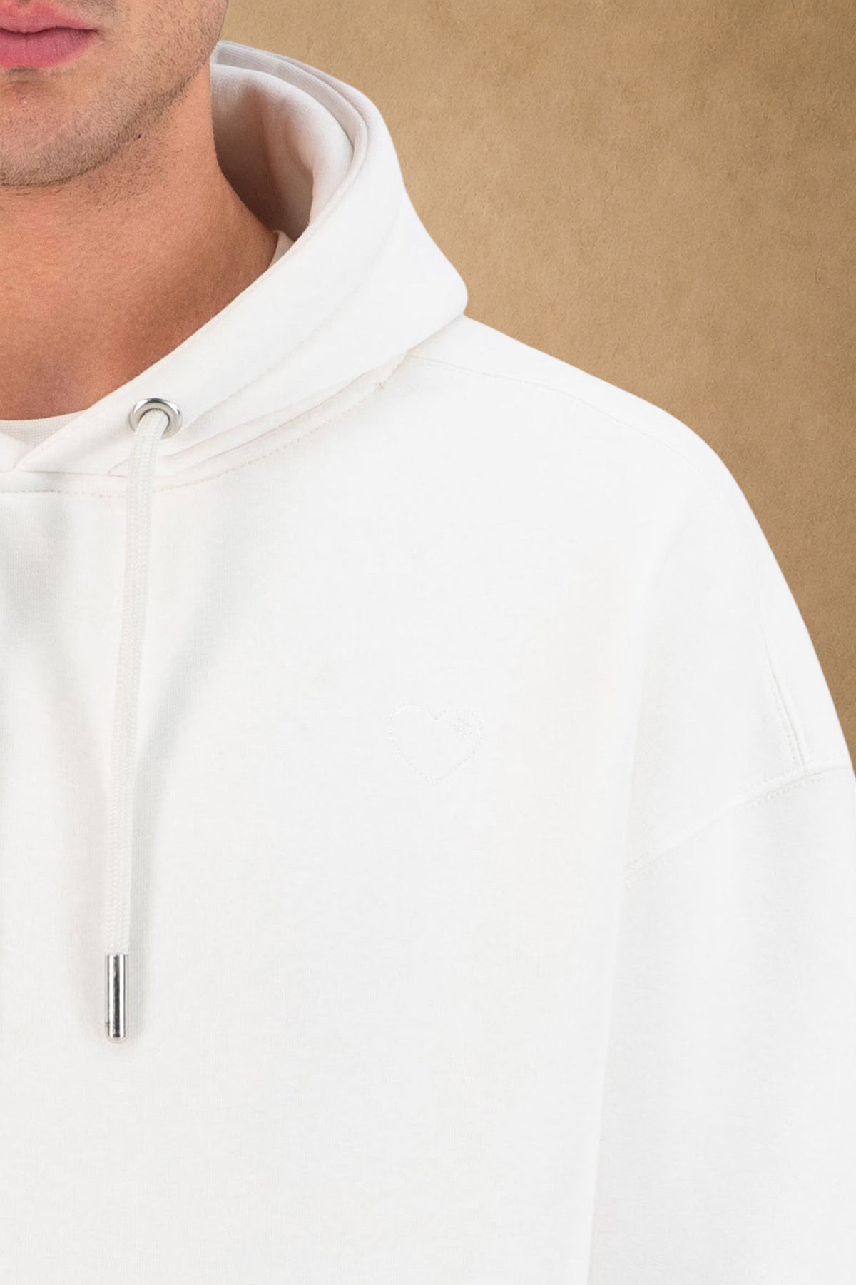 Stayin white quilted hoodie featuring a subtle embroidered heart detail and adjustable drawstring hood