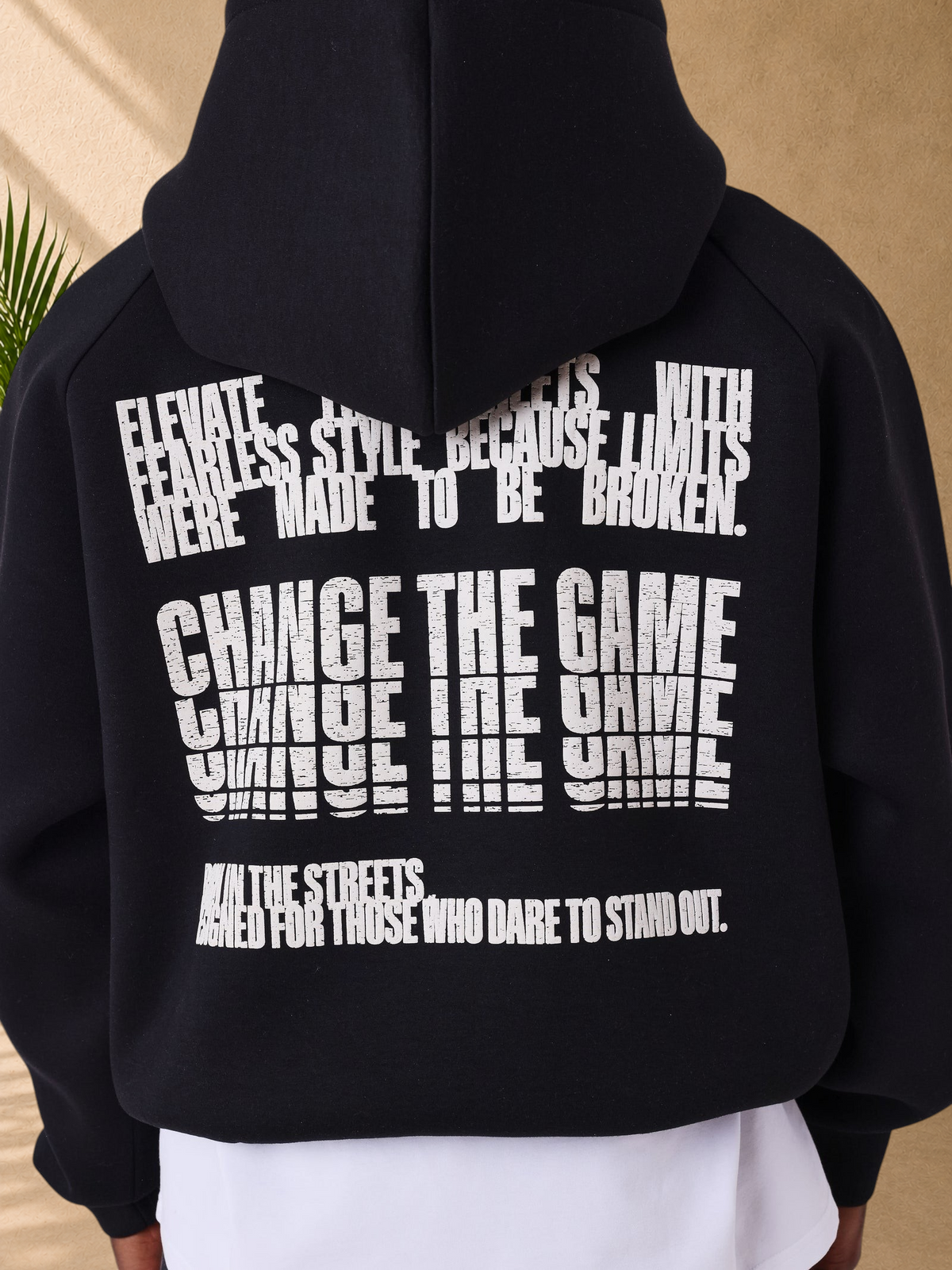 Stayin black hoodie with white distorted text graphic on the back and a drawstring hood