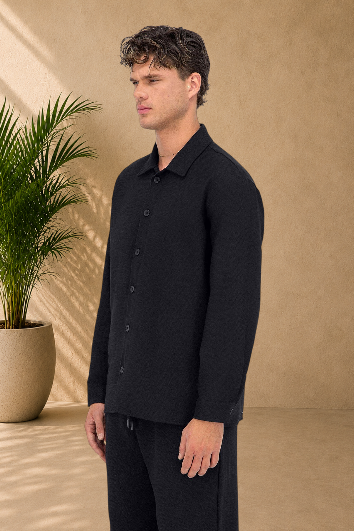 Stayin black quilted overshirt with button-down front worn by a model in profile view