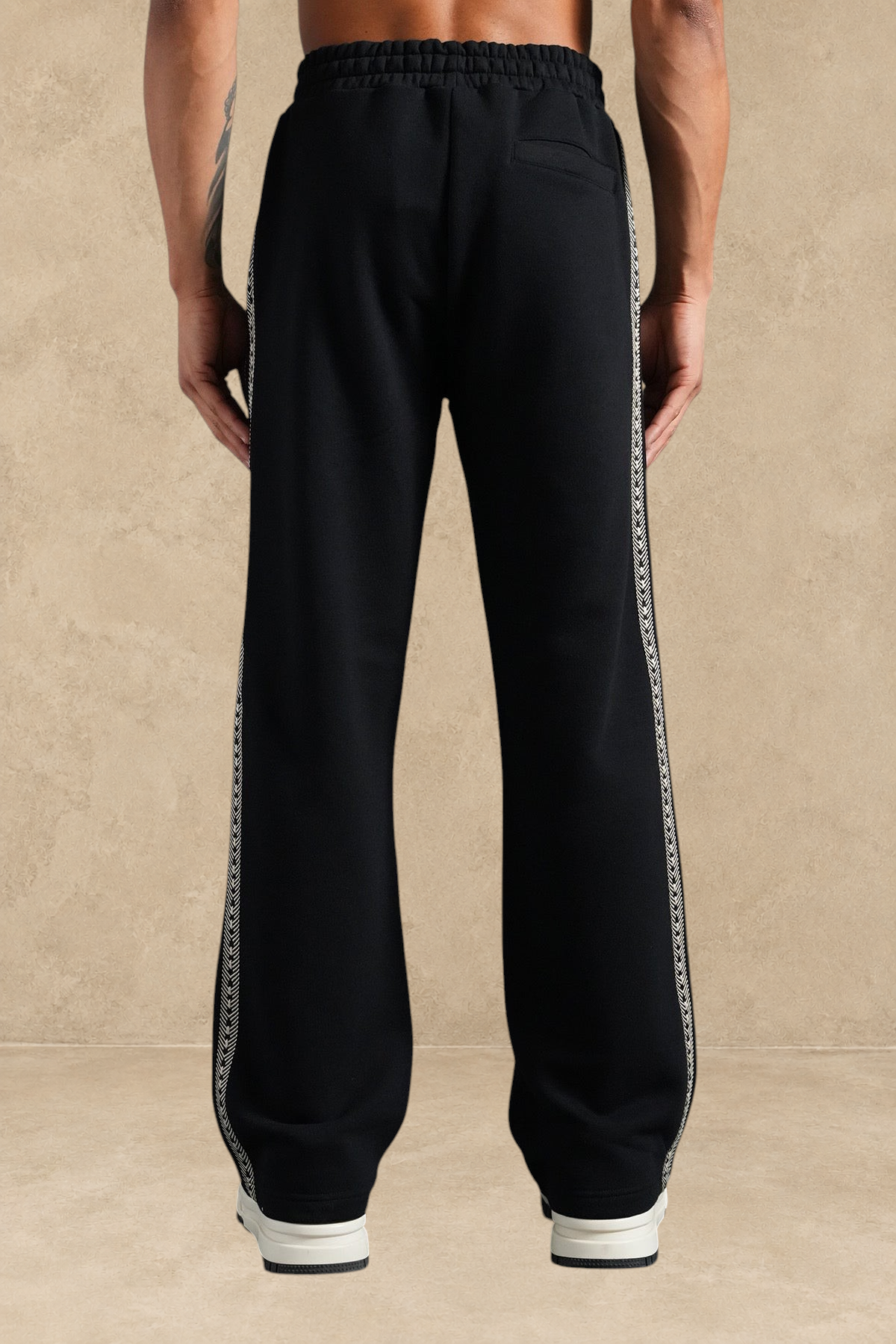 Pantalon Stayin noir à coupe large avec bandes latérales beiges à motifs, vue arrière sur mannequin