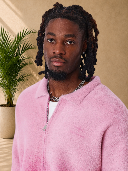 Stayin PXP pink fluffy oversized zip-up vest with a shirt collar worn by a man with dreadlocks