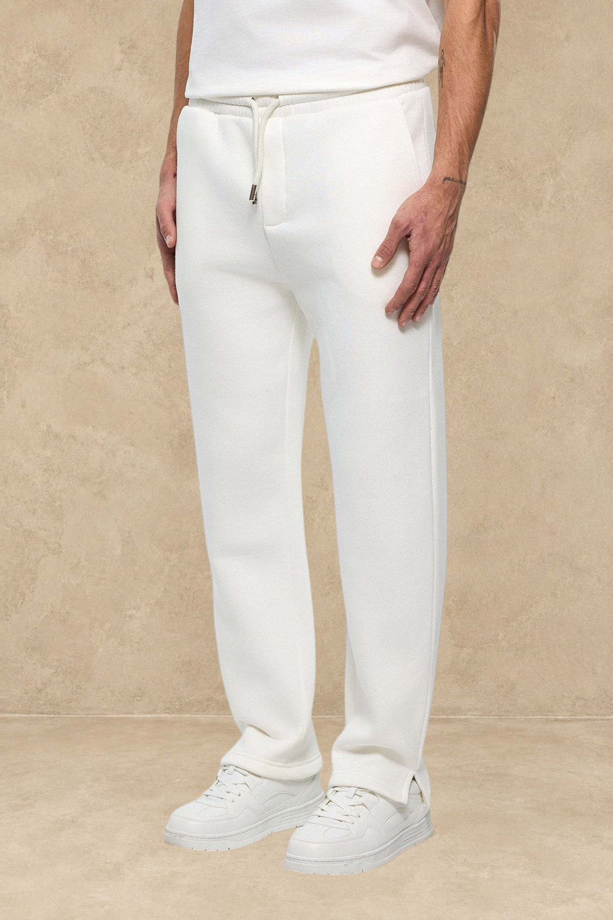 Pantalon jogger Stayin blanc avec coupe classique et fente à la cheville porté par un mannequin