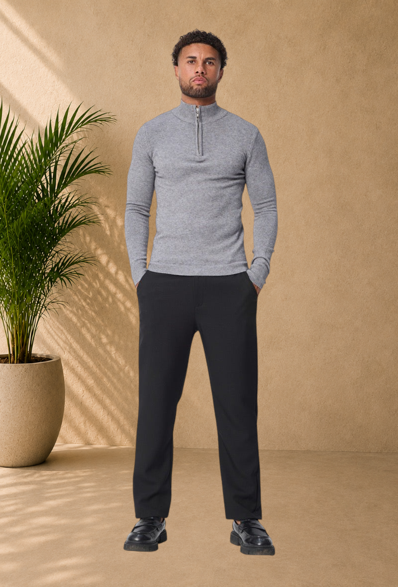 Stayin grey knit sweater with a zip-up mock neck worn by a model with black trousers and loafers