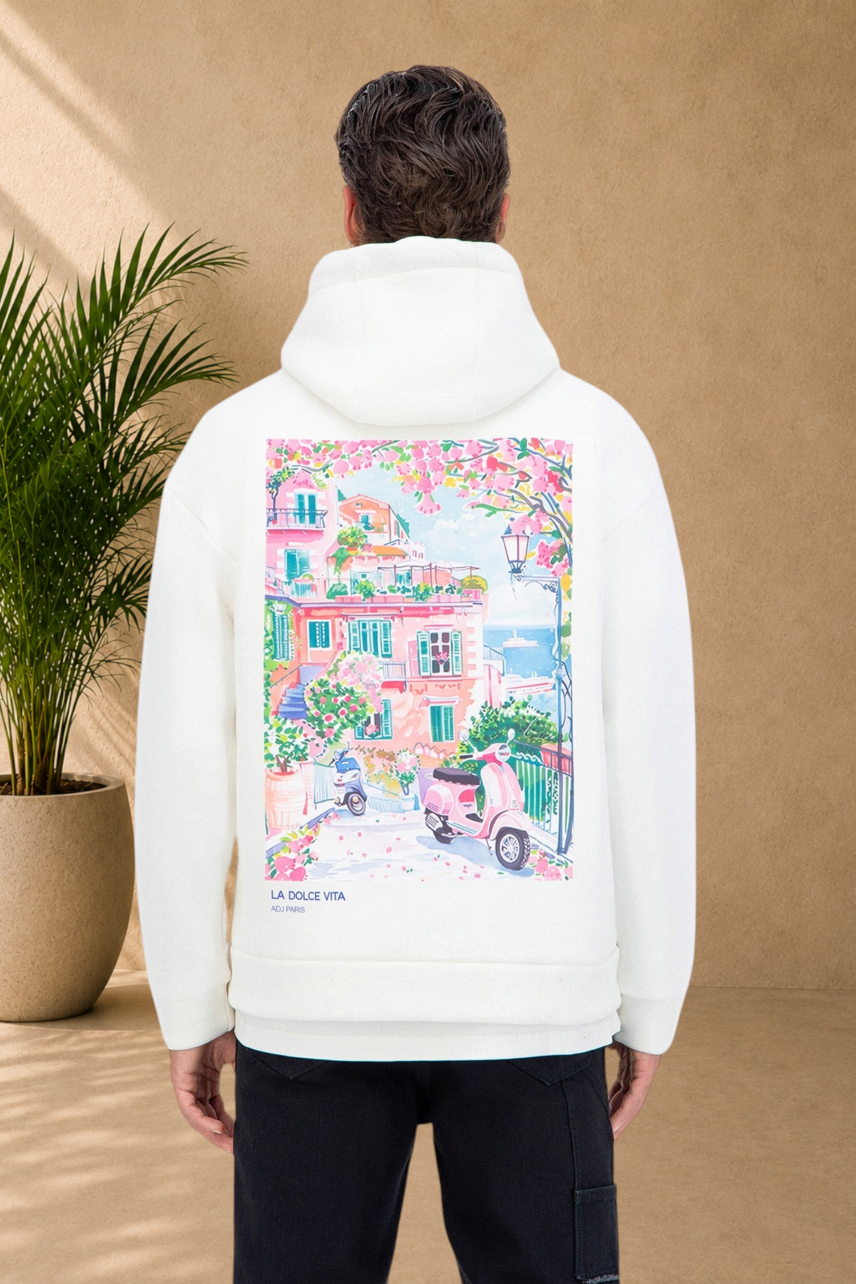 Stayin white quilted hoodie with a colorful Dolce Vita Italian coastal scene print on the back, worn by a model.