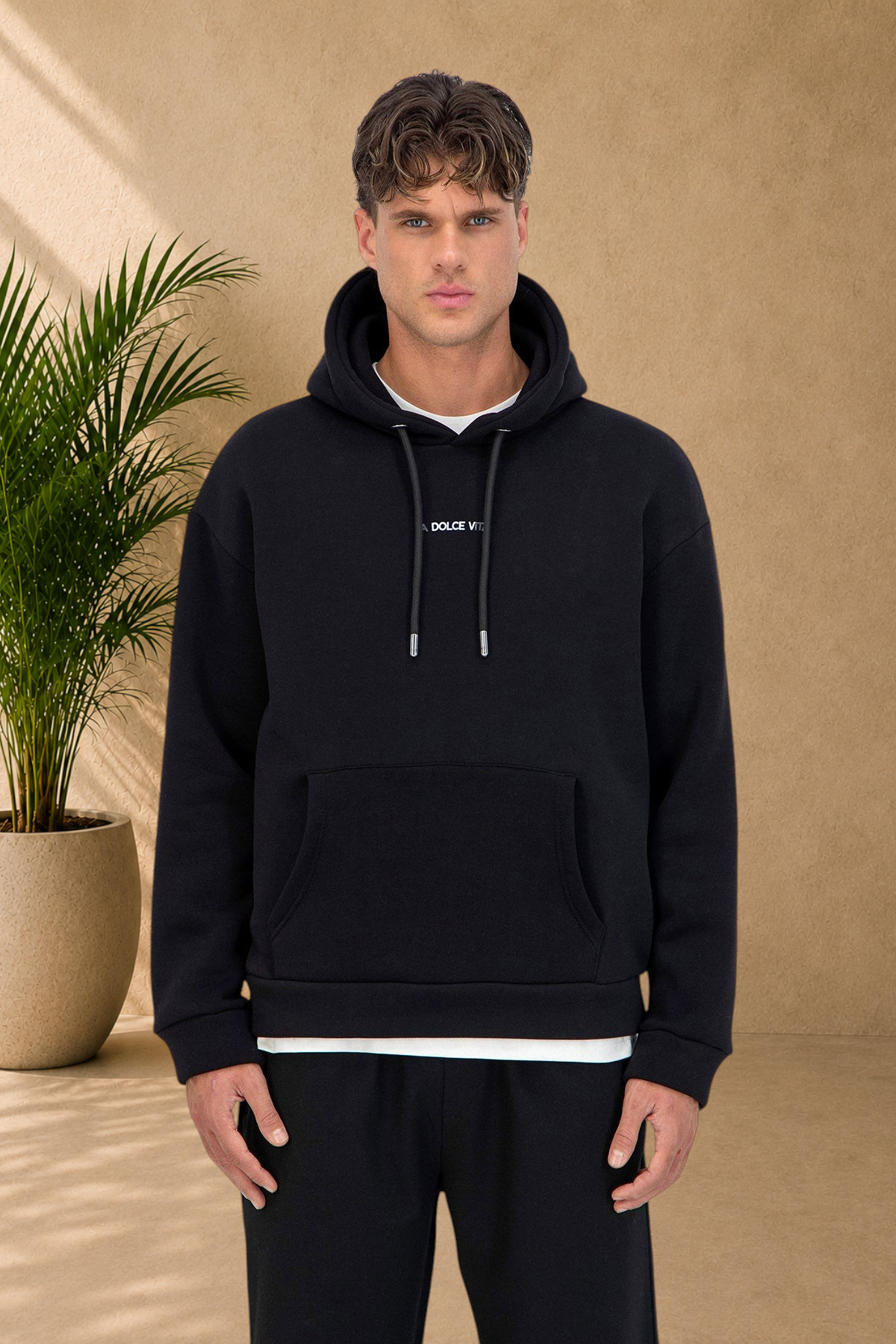 Stayin black Dolce Vita quilted hoodie with drawstring hood and front pocket worn by a male model