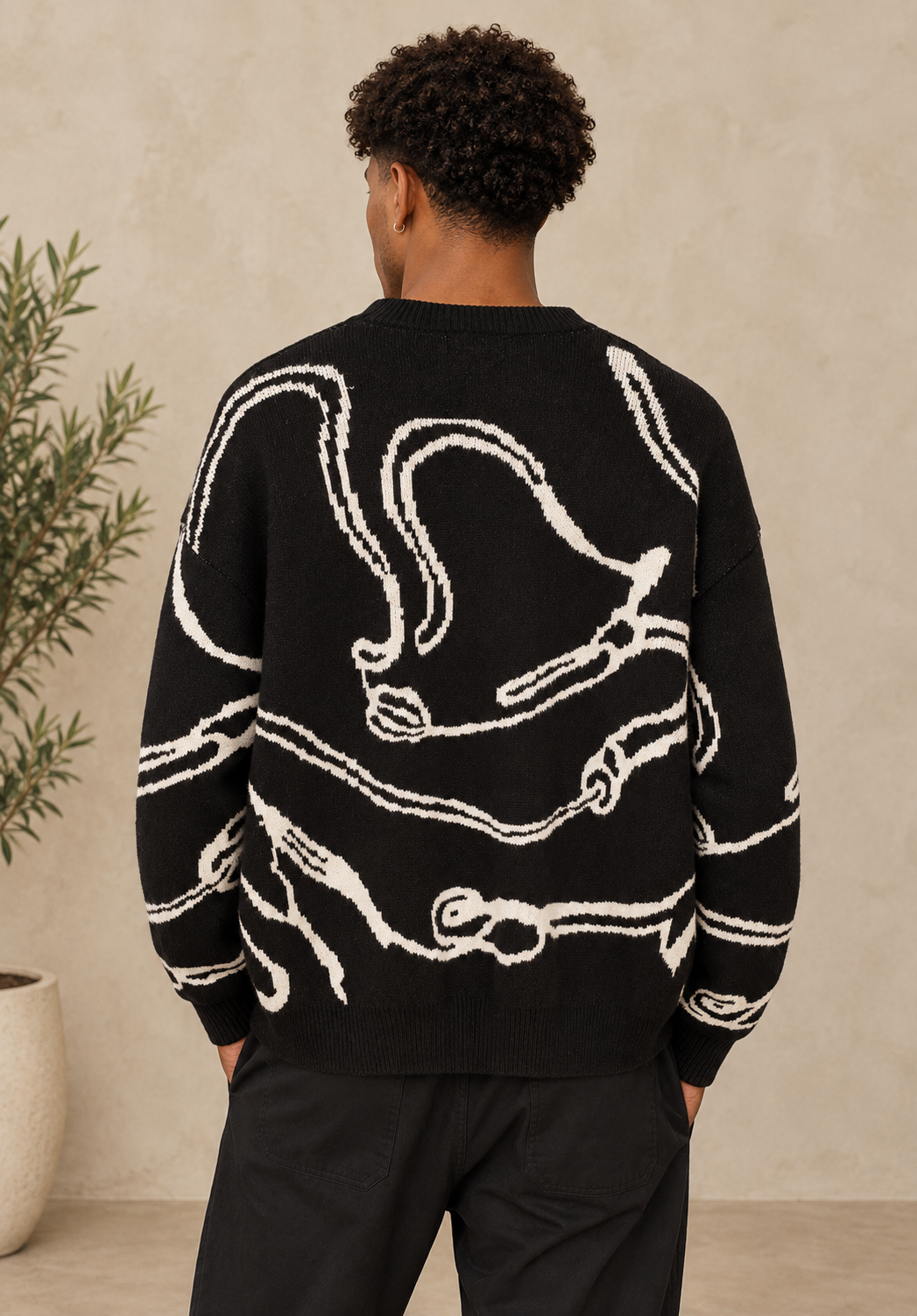 Pull noir motif beige